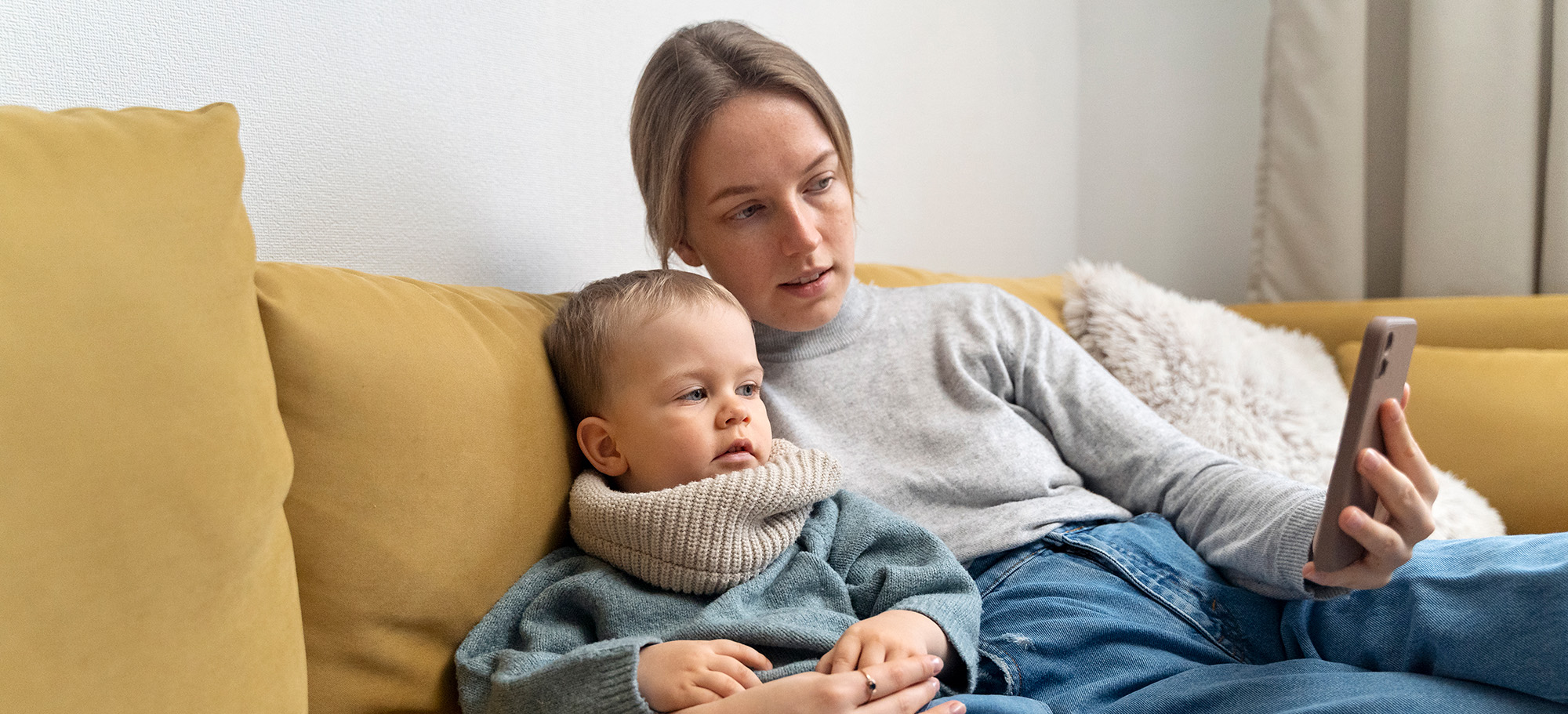 A mom with er child video chatting with someone on the phone